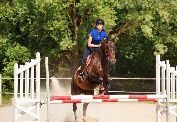 Jumping horse with horsewoman