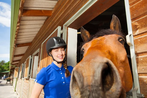Всадница со своей забавной лошадью смотрит в камеру — стоковое фото