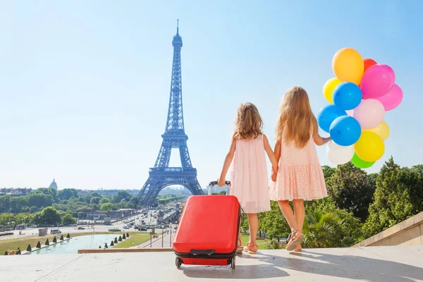Achteraanzicht Van Twee Kleine Meisjes Met Koffer Ballonnen Hand Hand — Stockfoto