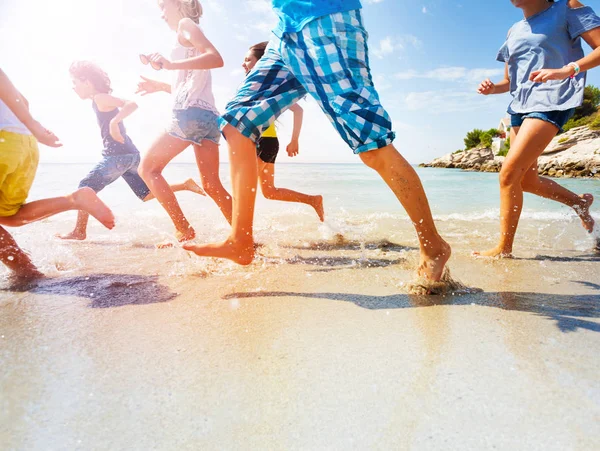 Piernas Los Niños Cerca Corriendo Playa Haciendo Salpicaduras Verano Día —  Fotos de Stock