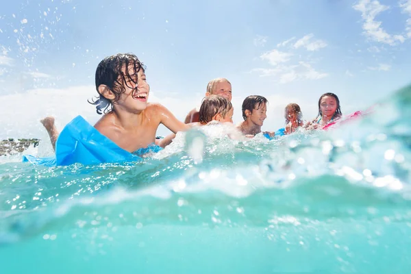 子供たちのグループが泳ぐし 友達と笑い半分の水中画像少年一緒に海の水で遊ぶ — ストック写真