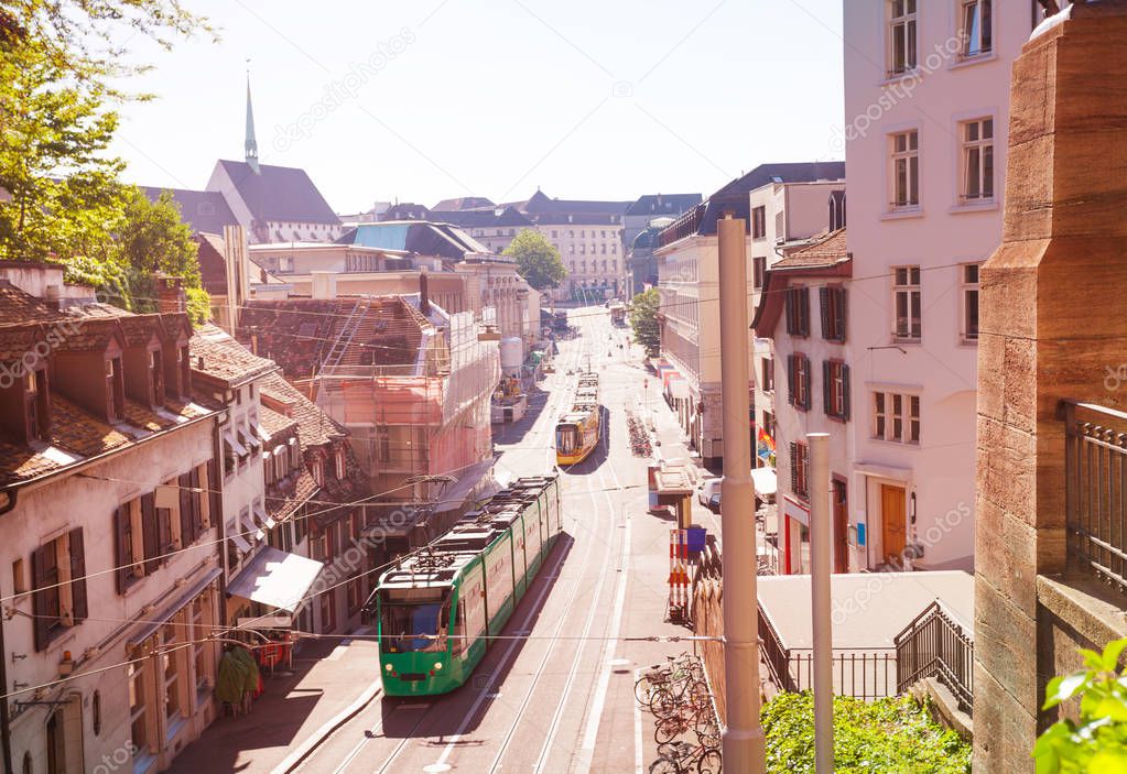 Aerial view of Basel streets with city trams, shops and ancient houses at sunny day