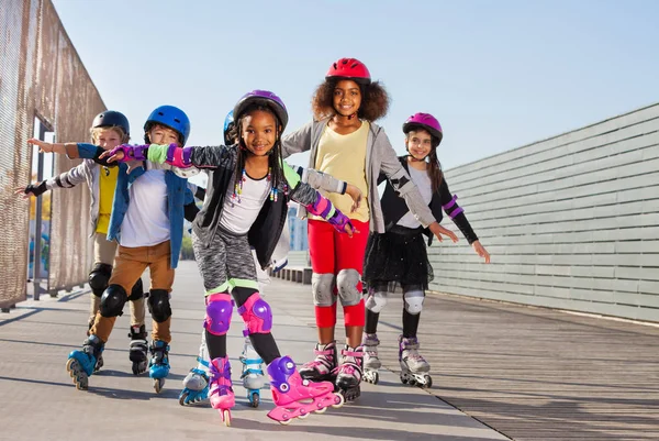 Preteen Wieloetnicznym Chłopców Dziewcząt Szczęśliwy Roller Łyżwiarze Stojąc Rękami Jak — Zdjęcie stockowe