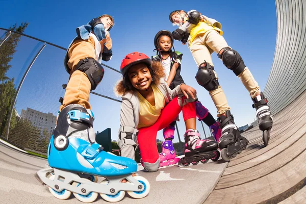 Low Angle Smiling African Girl Protective Gear Rollerblading Friends Outdoors — Stock Photo, Image