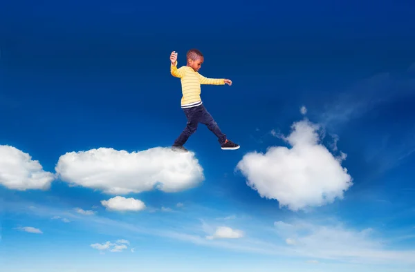 Little boy walking from one cloud to another — 스톡 사진