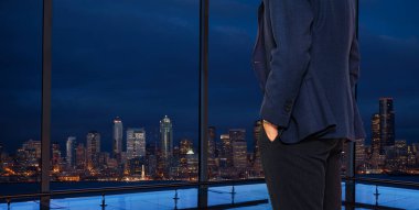 Man in suit stand at Seattle panoramic window, WA