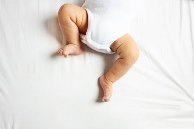 Close-up of newborn infant baby boy legs from top