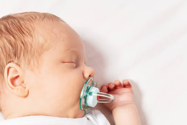 Face close portrait of newborn baby with pacifier — 스톡 사진