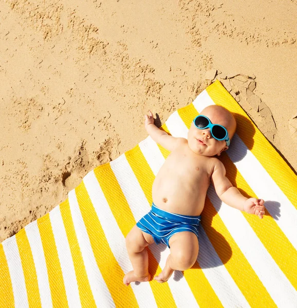 Little toddler baby infant laying on the beach mat — Stockfoto