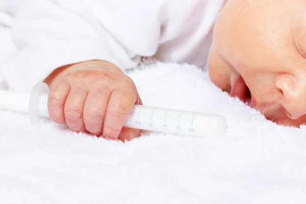 Newborn baby infant boy hand with medical syringe — 스톡 사진