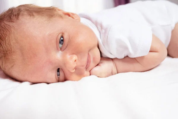 Close portrait of newborn baby boy lay on belly — Stok fotoğraf