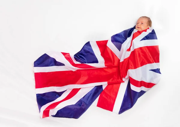 Portrait of newborn baby wrapped in UK flag — Stockfoto