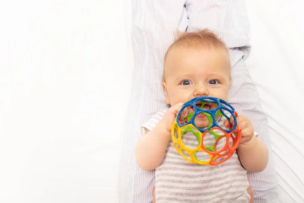 Baby boy toddler play and hold toy ball near mouth — Stock Fotó