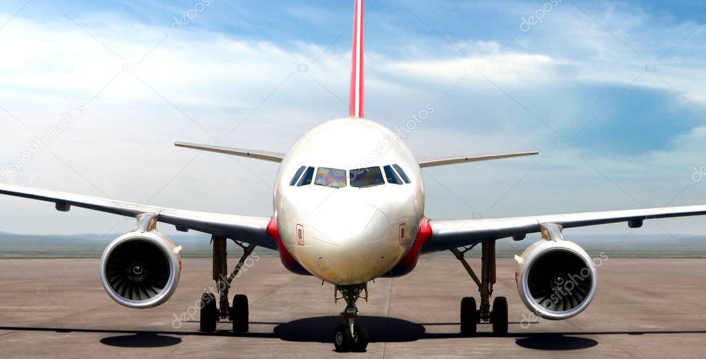 Airplane on runway preparing to take off in bright day light