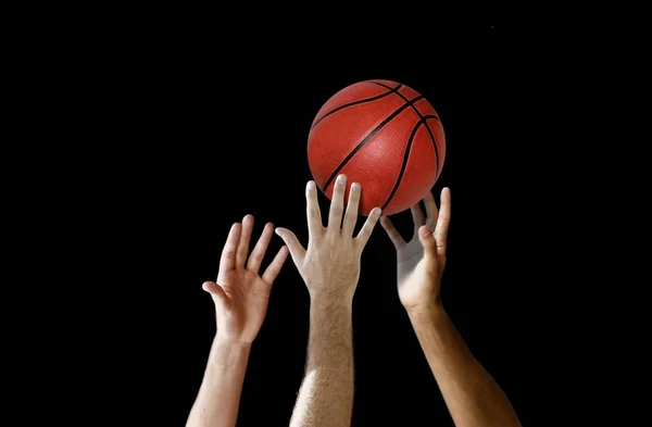 Players hand reaching for basketball in a competition — Stock Photo, Image