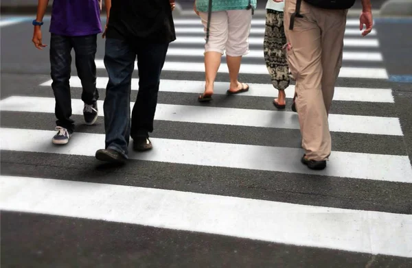 Menschen überqueren Straße im Berufsverkehr — Stockfoto