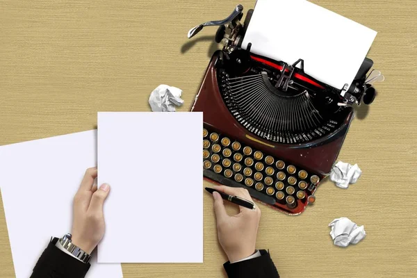 Vintage typewriter with author hand checking a paper sheets