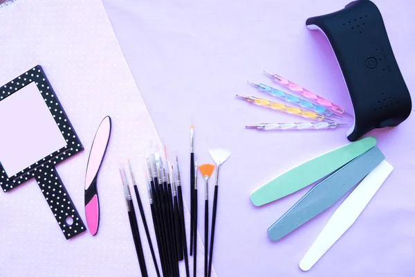 Nails Tools. On the cloth are the tools for manicure. Nail file, brushes, lamp uf — Stock Photo, Image