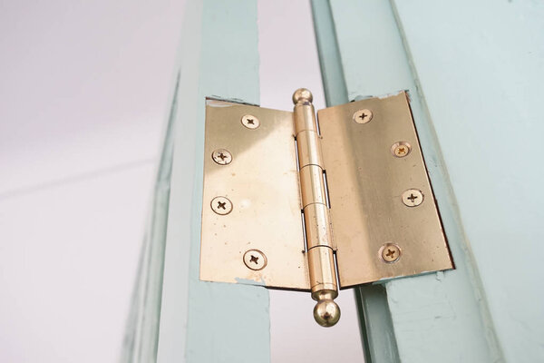 The golden hinges of the room door                               