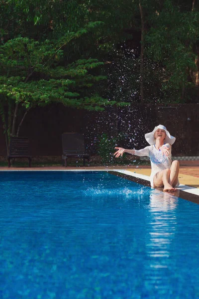 Young Woman Splashes While Sitting Pool — Stock Photo, Image