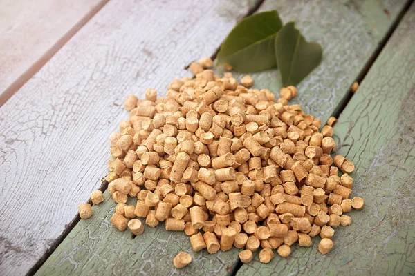 Wood pellets on a blue wooden background — Stock Photo, Image