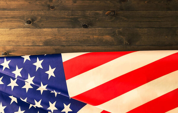 American flag lying on dark wooden background