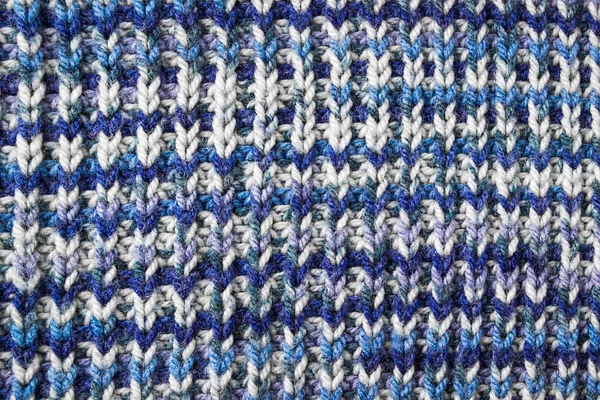 Blue knitted background. Knitted texture. A sample of knitting.