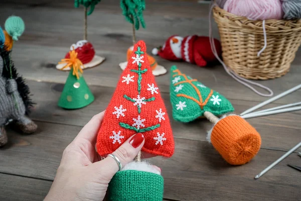 Knitted Christmas gifts handmade. Wooden background. Making knit New Year decoration. Christmas ornaments. — Stock Photo, Image