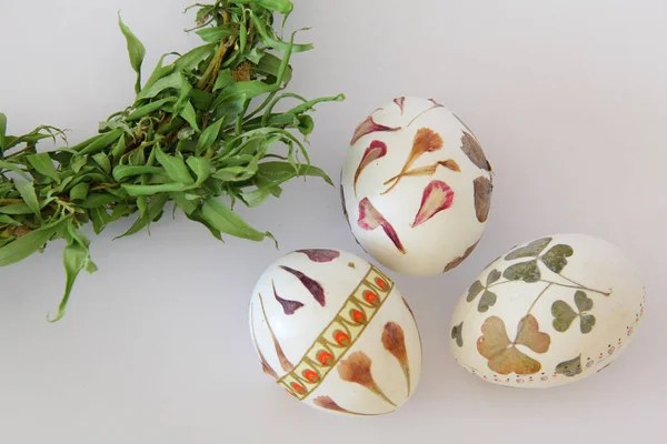 Easter eggs hand made decoration via decoupage technique by herbaceous flowers and leaves and color paper.