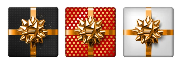 Ensemble de trois cadeaux décorés avec des arcs en or, sur un fond blanc — Image vectorielle