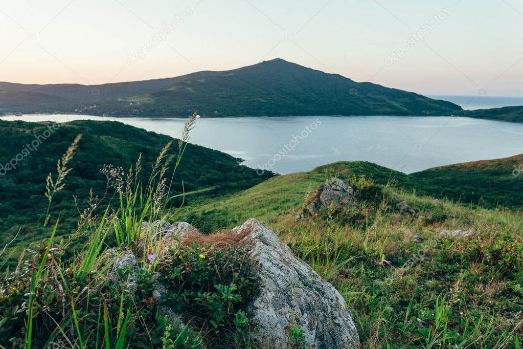 eraly sunrise over hills and sea bay