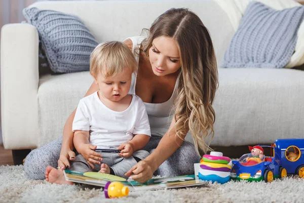 Linda madre y niño niño jugar juntos en el interior en casa —  Fotos de Stock