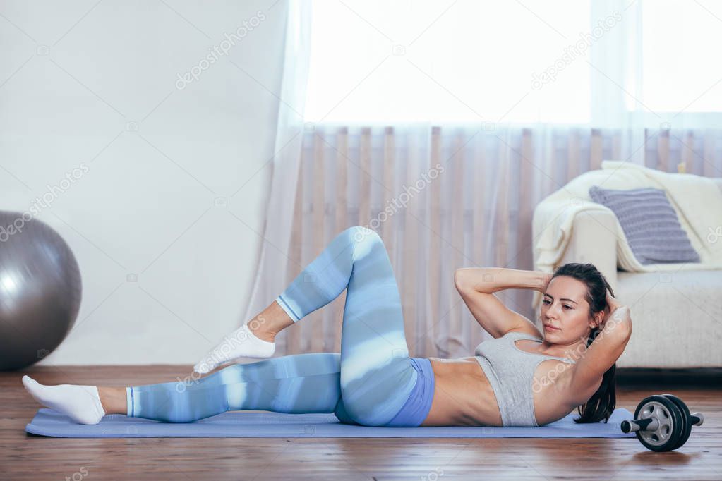 woman workout at home, her sit up