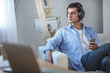 Yakışıklı adam smartphone ile internet üzerinden müzik dinlemek