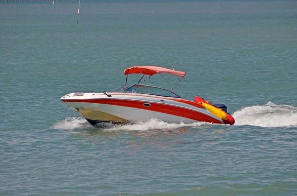 White Outboard Motor Boat with Red Trim — стоковое фото
