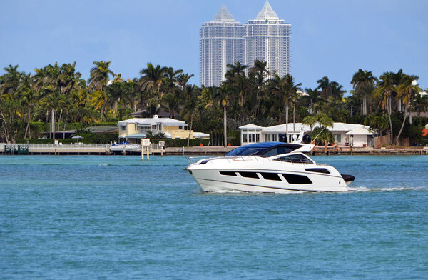 Высококлассный кабины крейсер на Флориде внутриприбрежный водный путь на заднем плане роскошный отель возвышается в. Майами-Бич
.