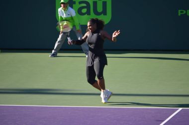 Serena Williams returning serve against Naomi Osaka in their first round match of the Miami Open tennis tournament at Crandon Park,Key Biscayne ,Florida on 21 March 2018. Ms. Osaka won in straight set 6-3,6-2. clipart