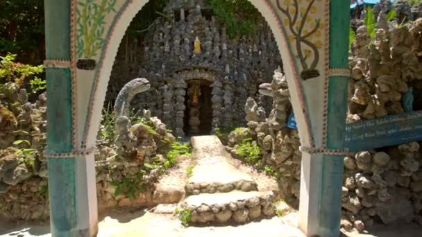 Path through gate to entrance of modern church — Stock Video