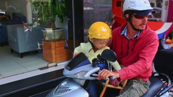 Дівчина сидіння перед батьком на мотоциклі — стокове відео