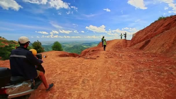 Tourists stand on slope of hill by ground road — Stock Video