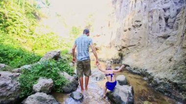 Baba küçük kızı el yürüyüş dar akışında alır.