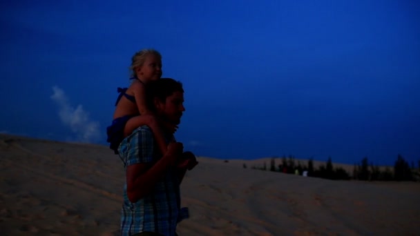 Baba kız Dunes omuzlarında üzerinde tutarak yürür — Stok video