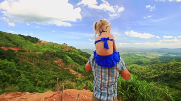 Père tient la fille sur les épaules contre la vallée — Video