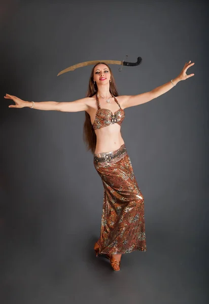 Tancerka brzucha z szablą na głowę o pełnej wysokości — Zdjęcie stockowe