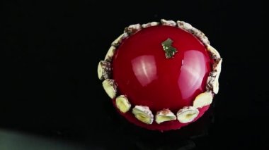 mus tatlı kurutulmuş muz ile dekore edilmiş ve ayna siyah arka plan üzerinde kırmızı sır ile kaplı