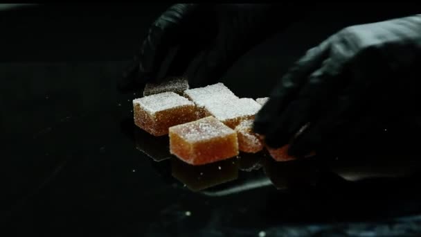 Confectionery Hands Hands Put Lot Orange Marmalade Coated Sugar Black — Stock Video