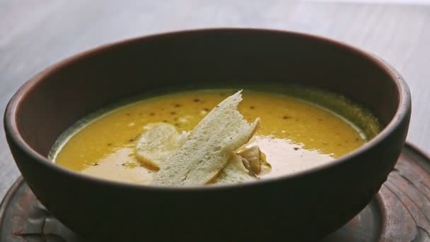 Nahaufnahme Käse-Sahne-Suppe exquisit mit Pilzen und getrocknetem Brot dekoriert — Stockvideo