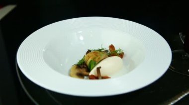 Beyaz mantarlı, beyaz peynirli ve dereotlu, siyah arka planda servis edilen beyaz restoran tabağını yakınlaştır.