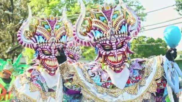 Closeup men in vivid masquerade costumes pose for photo at dominican carnival — стокове відео