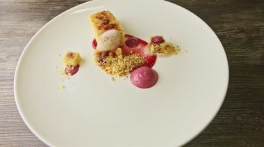 exclusively decorated sliced sponge cake with syrop rotates on white plate
